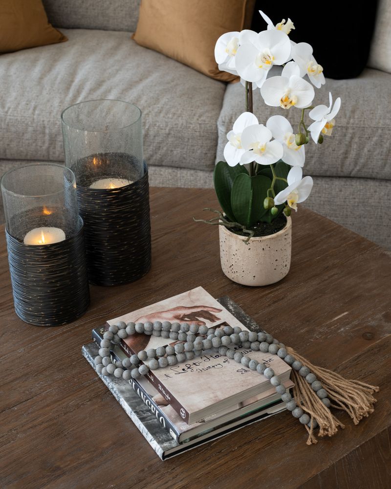 table decor of candles, flowers, and books